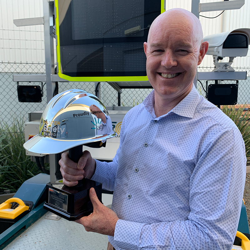 Jeremy Pola holds the Hunter Safety Award which is a shiny hard hat trophy