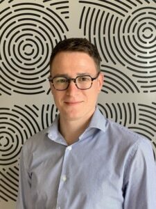 Photo of Oleg in front of a patterned background