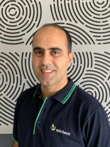 Photo of Sam in front of patterned background