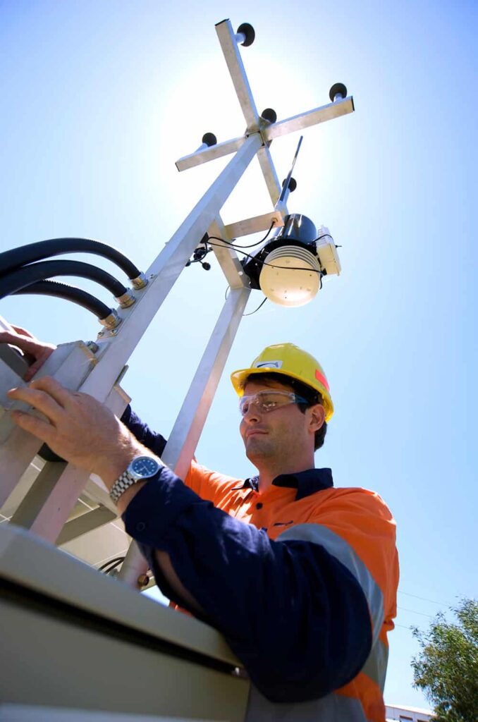 Man with environmental monitoring equipment in the field